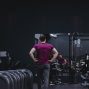 Man in a gym with fitness equipment, highlighting a healthy lifestyle.